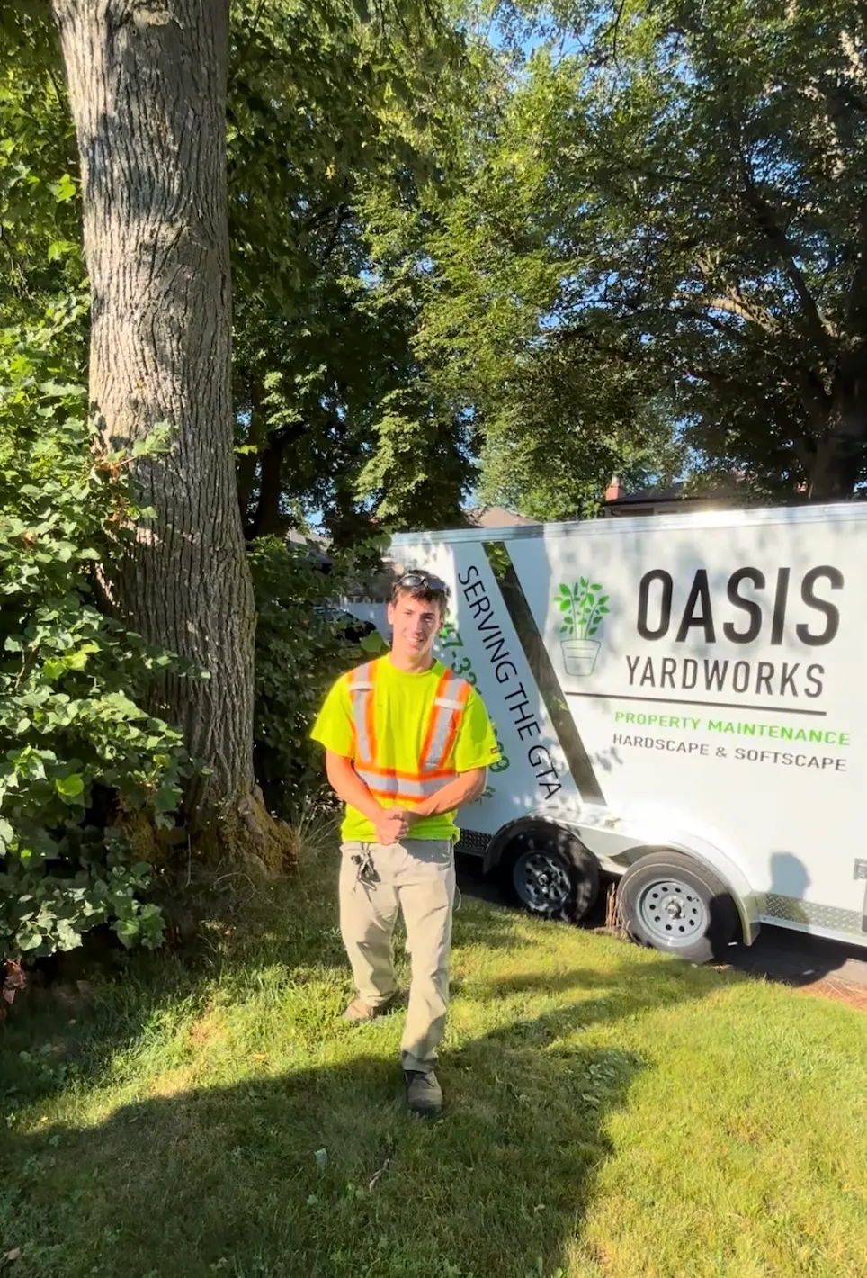 Michael Silveira of Oasis Yard Works beside the company trailer